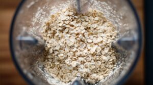 Rolled oats in a blender being processed into oat flour