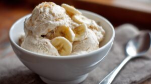 Bowl of creamy banana ice cream with sliced bananas on top