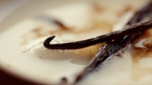 Close up of vanilla pods in milk creating a rich creamy base