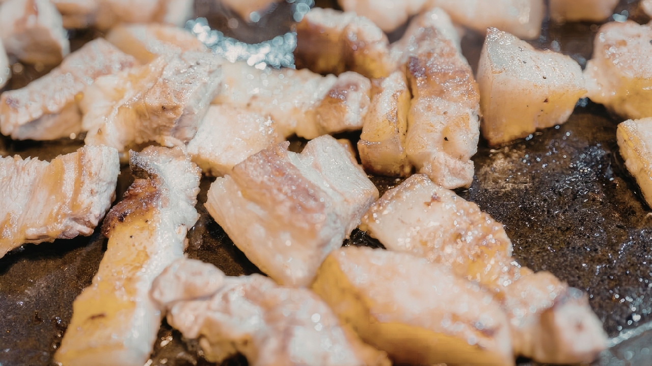 Cooked chicken pieces on a pan with visible frost and ice crystals