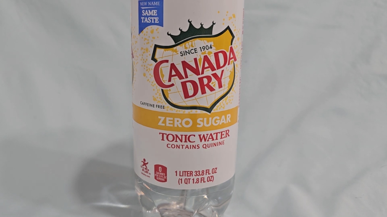 A bottle of Canada Dry Zero Sugar Tonic Water on a plain surface
