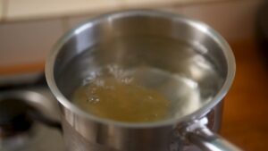 Egg poaching gently in simmering water.